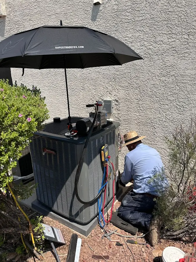 HVAC technician performing outdoor AC maintenance in Lexington Park