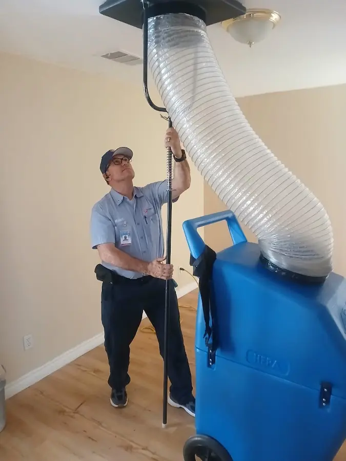 Furnace Tune-Up technician using HEPA equipment in Lexington Park